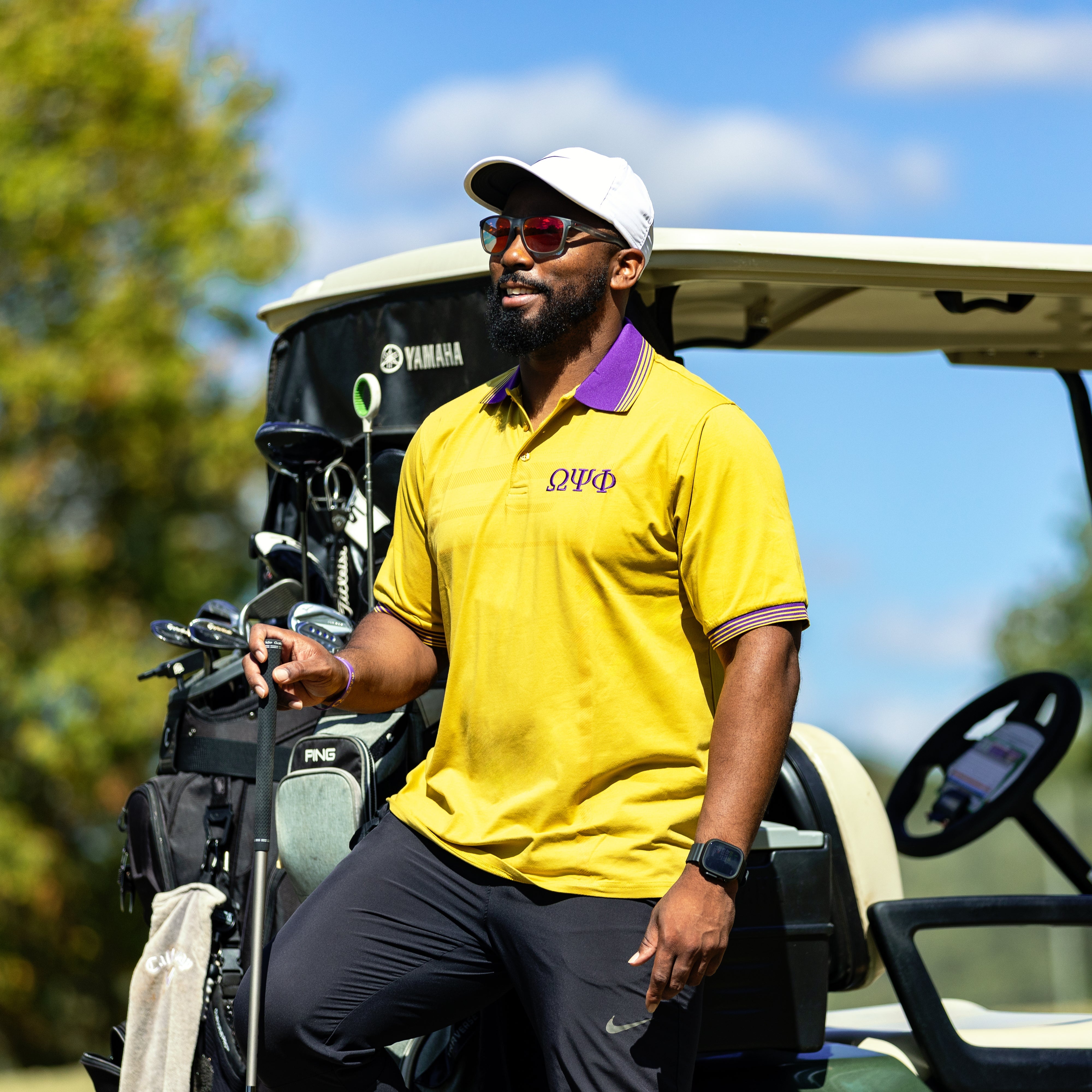 Gold Omega Psi Phi Polo with Purple Collar Winters Industries