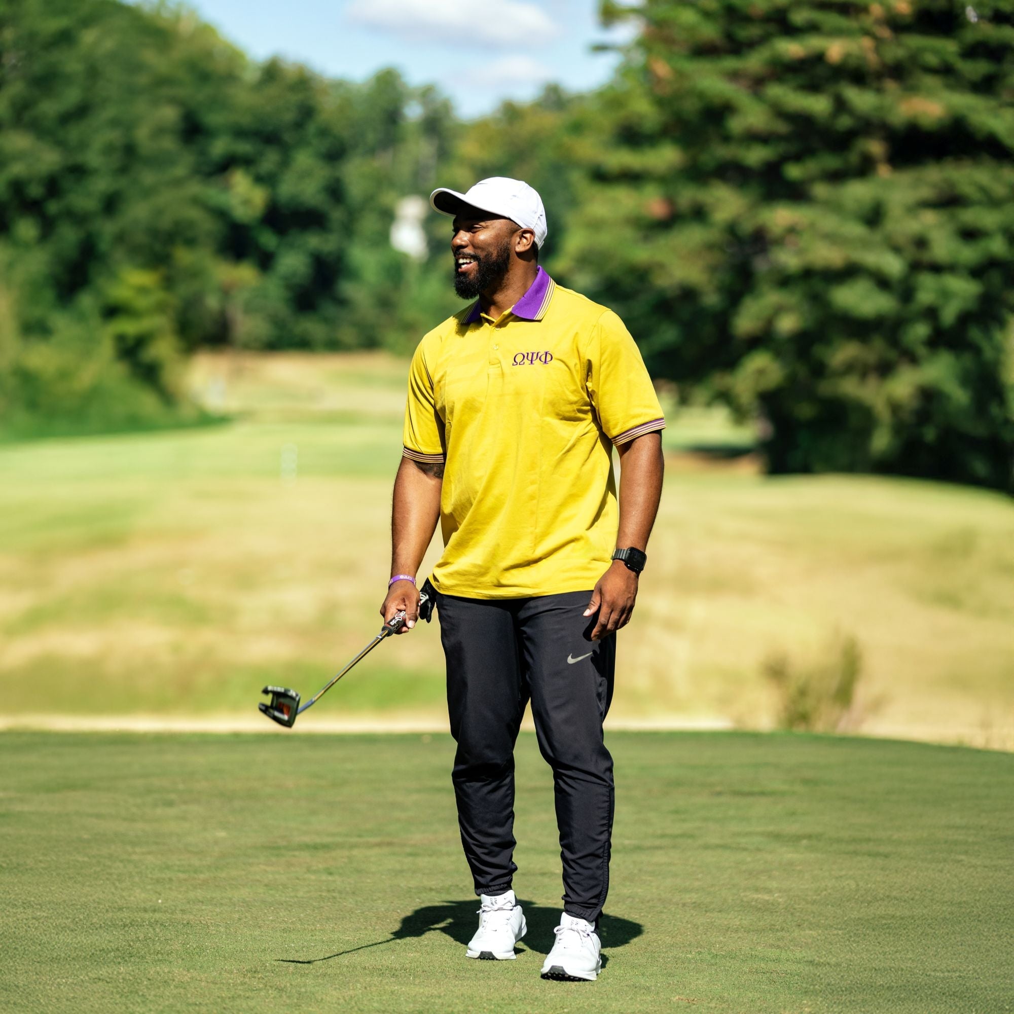 Gold Omega Psi Phi Polo with Purple Collar Winters Industries