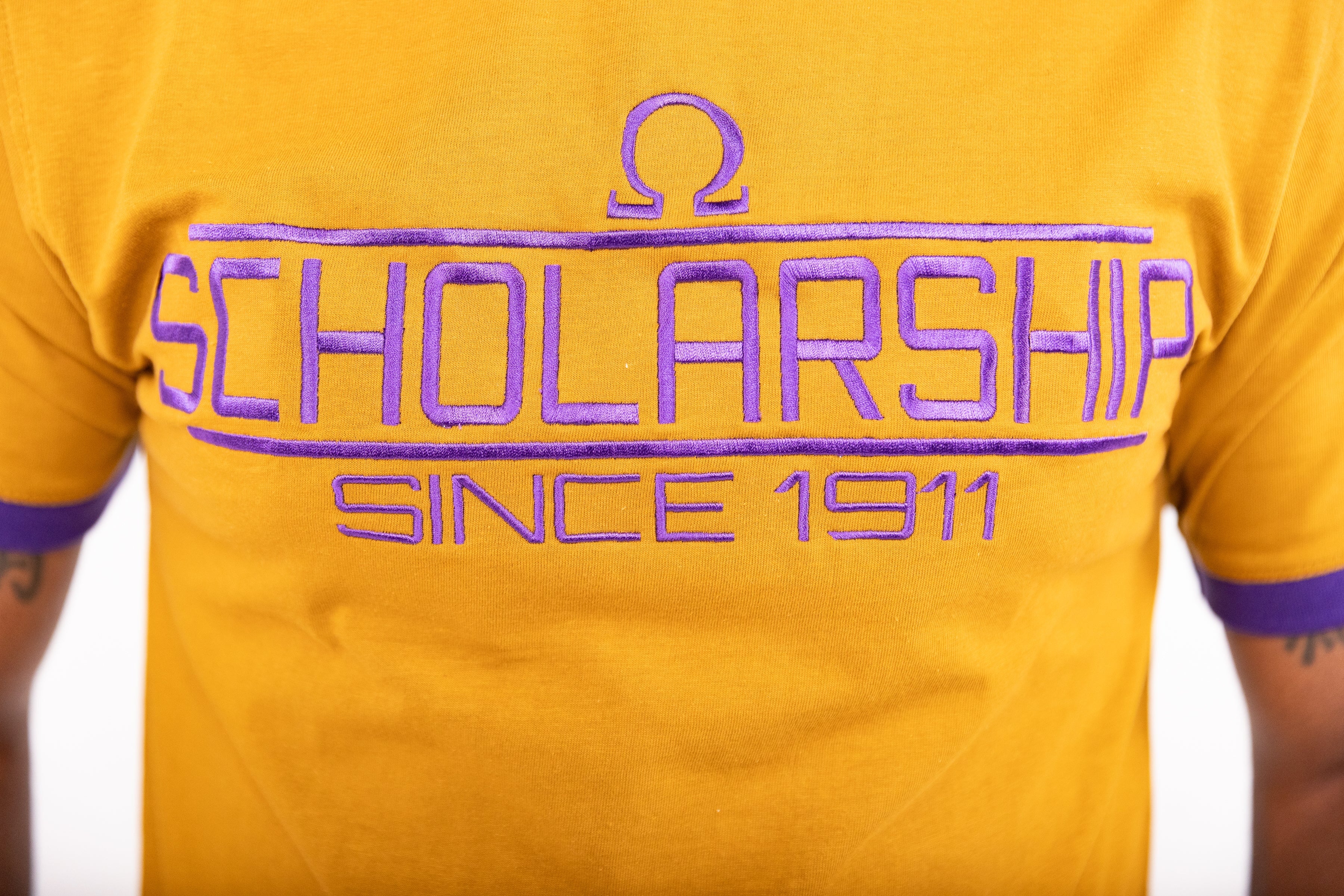 Omega Psi Phi "SCHOLARSHIP" Embroidered Tee Gold